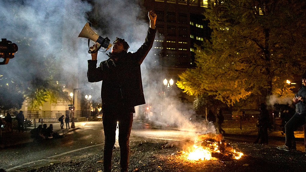 Riot declared in Portland; Denver police clash with protesters