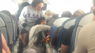 Dramatic moments on packed plane has passengers being hailed as heroes