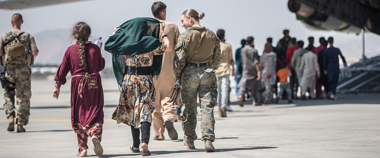 Female soldier and Afghan women