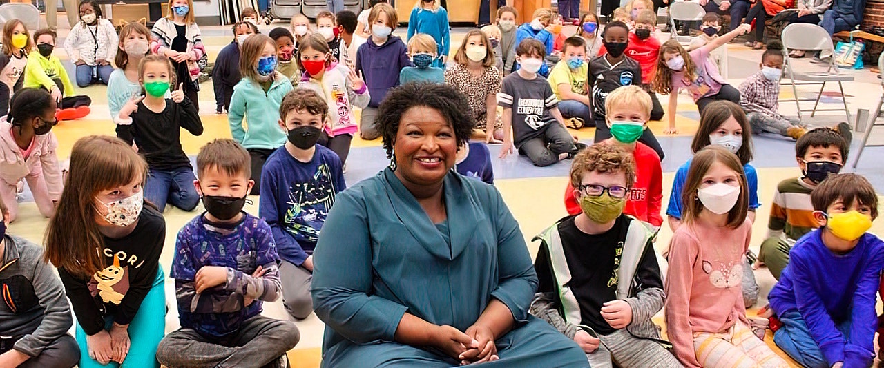 Democrat Stacey Abrams beams in maskless photos surrounded by young children forced to mask up