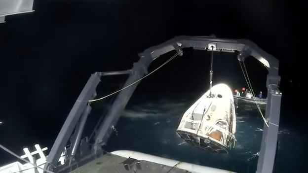 Recovery teams secure Dragon after splashdown