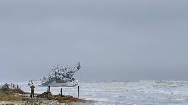 Hurricane Ian waves and wind wash large boat ashore