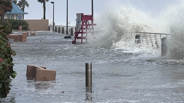 Large waves crash onto boardwalk at Daytona Beach
