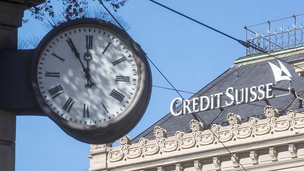 Credit Suisse pays down debt to calm investors