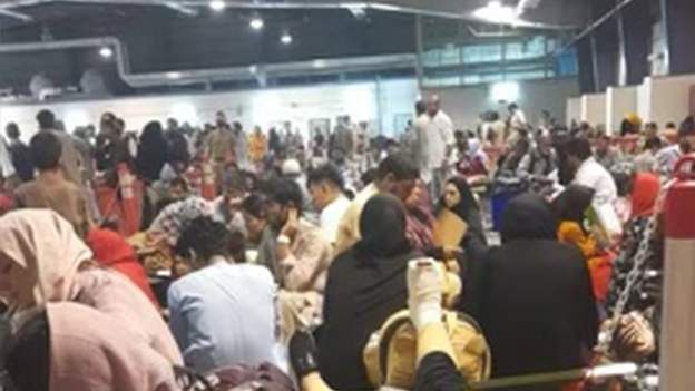 Crowded conditions as evacuees processed in Qatar