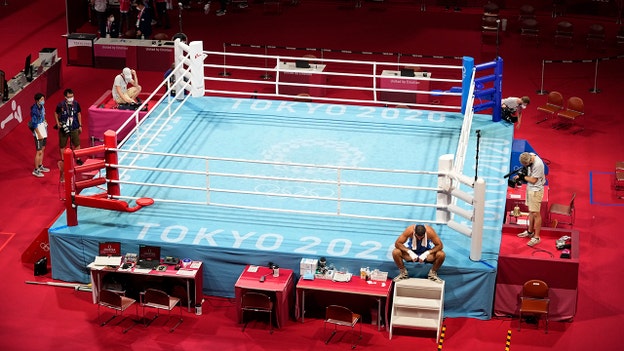 French Olympic boxer protests by sitting on ring apron after disqualification