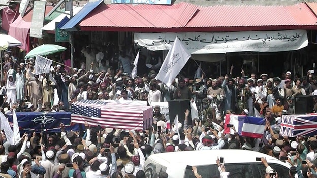 Taliban supporters hold mock funerals with coffins draped with American flags