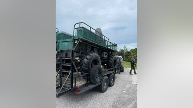 Florida Wildlife Conservation officers, joined by bloodhounds, bring amphibious swamp buggy into sea