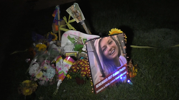 Neighbors add large photo of Petito with “Remember me?” written on it to memorial on Laundrie proper