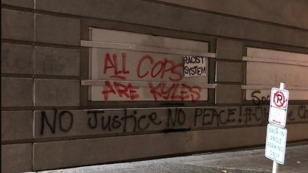 Portland rioters graffiti downtown precinct, writing: 'All cops are Kyles'