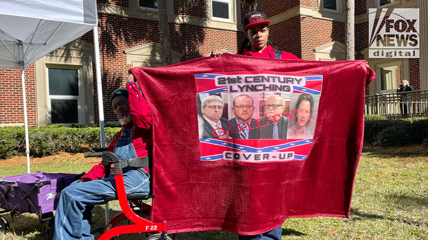 Protesters hold up signs outside courthouse, pray for 'justice'