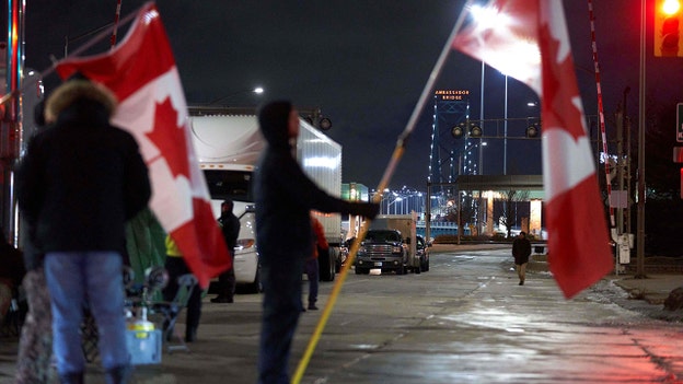 ‘Freedom Convoy’ protesters stay on bridge all night; police crackdown never happens