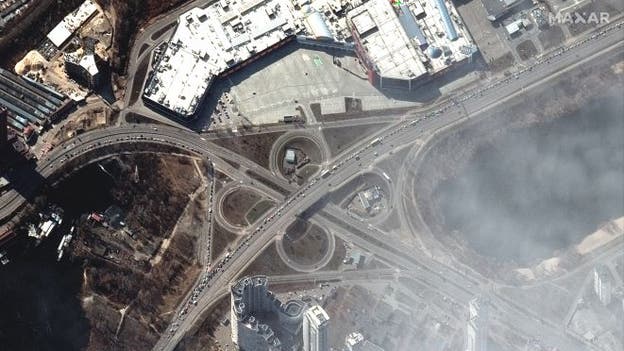 Satellite imagery shows long lines of cars attempting to flee Kyiv as Russian troops close in