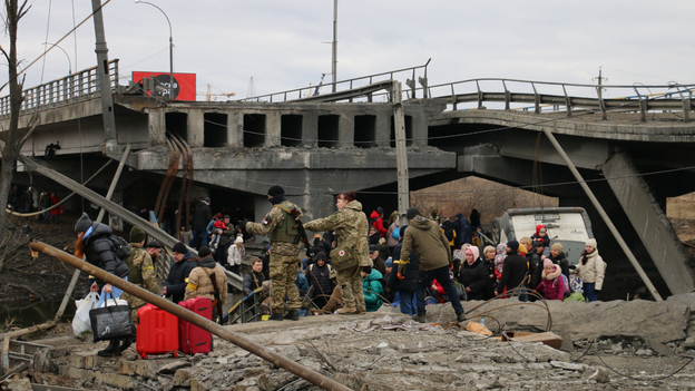 Picture shows Ukrainians under destroyed bridge attempting to flee city