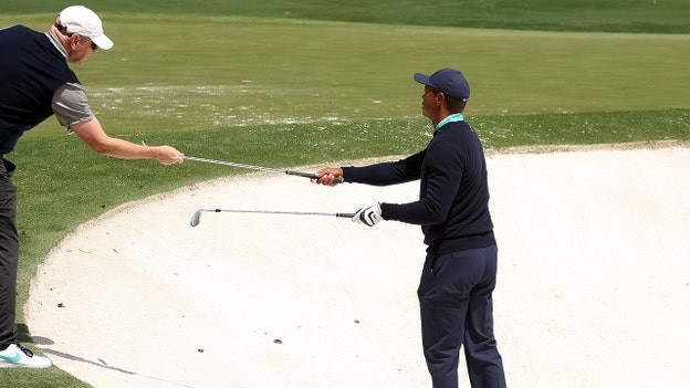 Tiger Woods warms up before second round