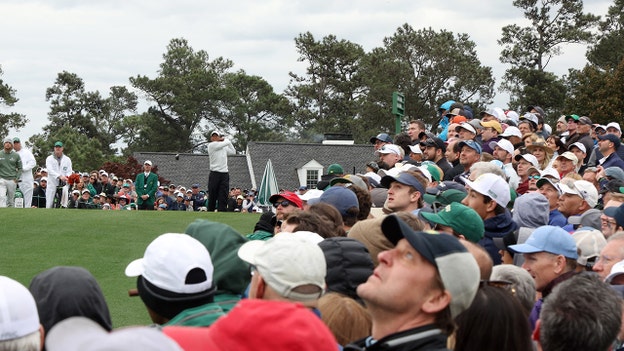 Tiger Woods tees off on first