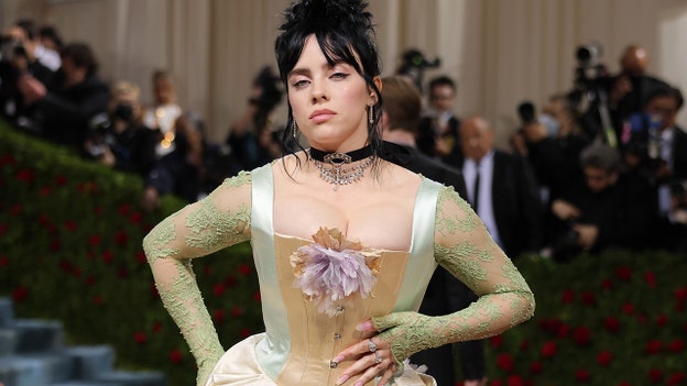 Billie Eilish rocks tight-fitting corset coupled with lavender and green floral accents