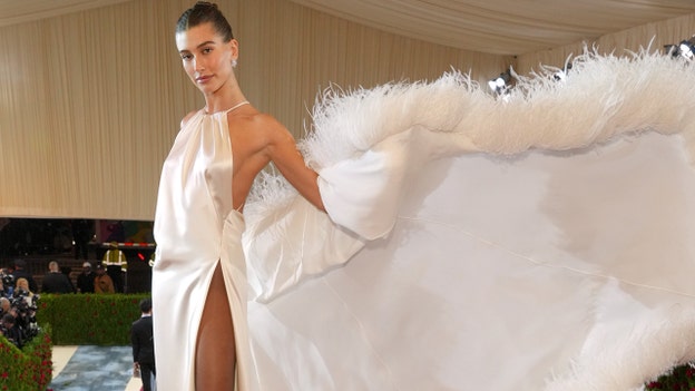 Hailey Bieber spreads feathered wings in regal white ball gown following hospital stay due to stroke