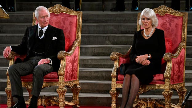 King Charles III and Camilla, Queen Consort, sit on the throne for the first time