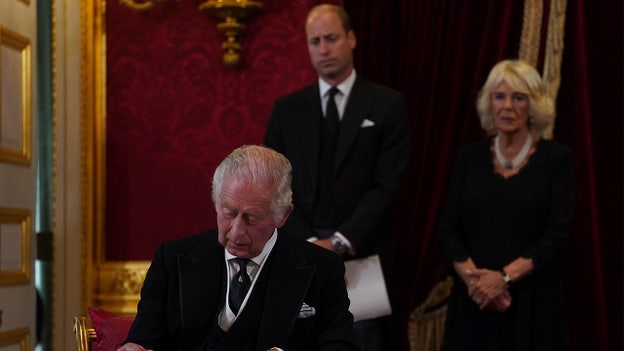 King Charles III signs oath as family members look on