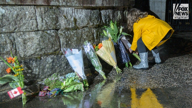 Child lays flowers outside Balmoral where Queen Elizabeth died