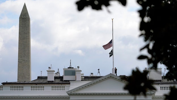 The American flag flies at half-staff over the White House