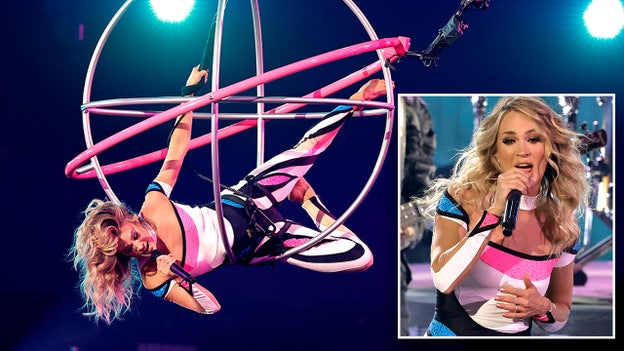 Carrie Underwood flies above the crowd during aerial performance