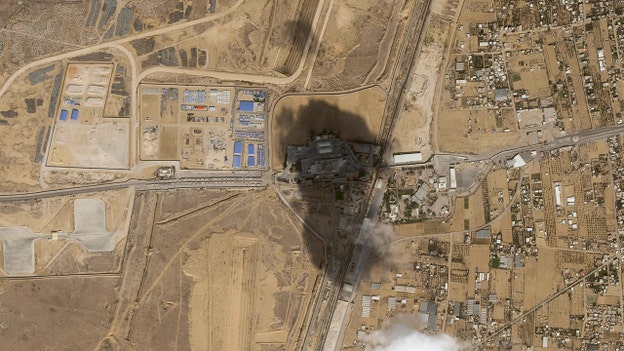 Satellite photos show convoy of aid trucks waiting to cross into Gaza