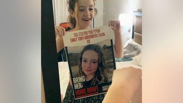 Irish-Israeli girl, 9, freed from Hamas seen smiling holding missing person poster with her image