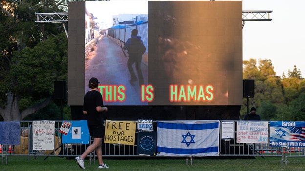 Pro-Israel counter-protesters loop Oct. 7 footage on big screen at UCLA