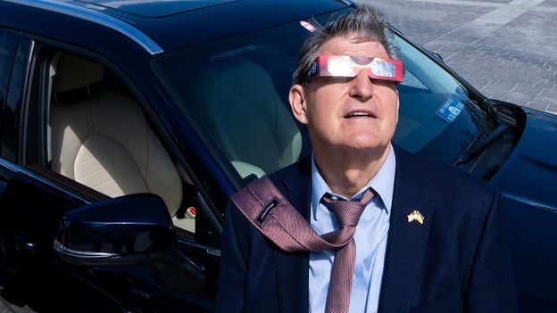 Sen. Joe Manchin stares at solar eclipse from Washington