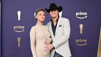 Country music singer, wife shock with baby announcement on ACM red carpet