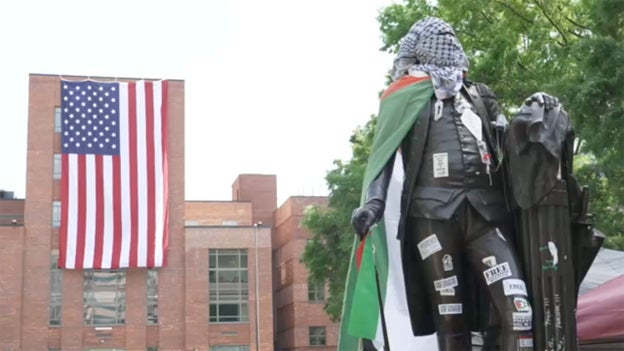 Large American flag unfurled at George Washington University above anti-Israel protesters
