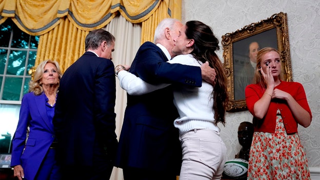 Biden surrounded by family, staff during Oval Office address