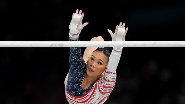 Suni Lee all smiles after earning 14.866 on uneven bars