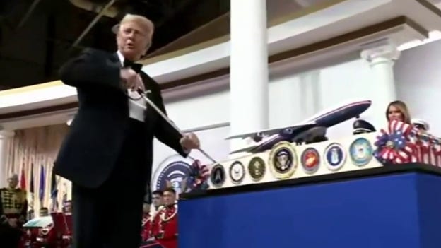 President Trump cuts cake with sabre at Commander-in-Chief Ball