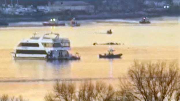 First responders are searching the Potomac River as the sun rises in Washington, DC