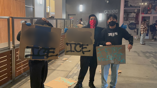 Young protestors in Los Angeles hold anti-ICE signs