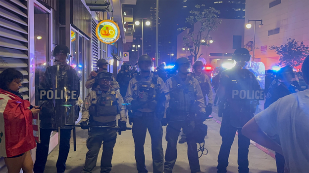 Riot police stand guard during protests in downtown Los Angeles