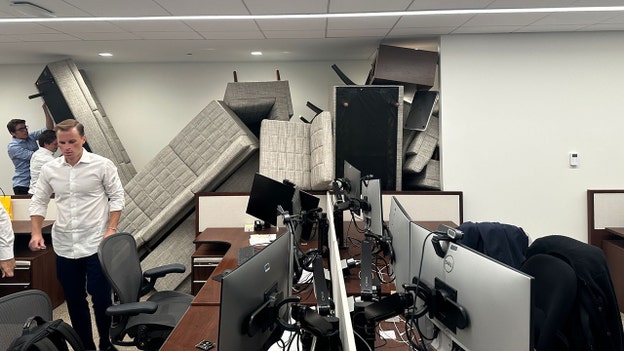 Desperate office workers stack furniture as armed gunman stalks Manhattan high-rise building