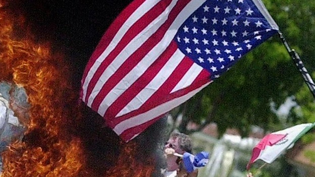 Protester burns US flag near scene of fatal ICE-involving shooting