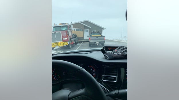 Home under transport blown off trailer in SD