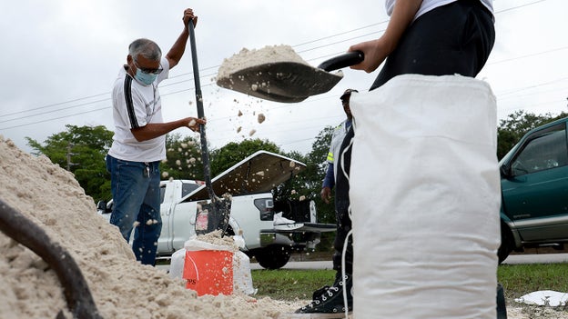Florida residents fill sand bags ahead of potential flooding