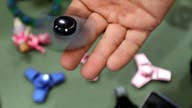 Popular toy fidget spinners catch fire, families say