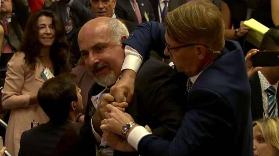 Protester removed from Trump-Putin news conference