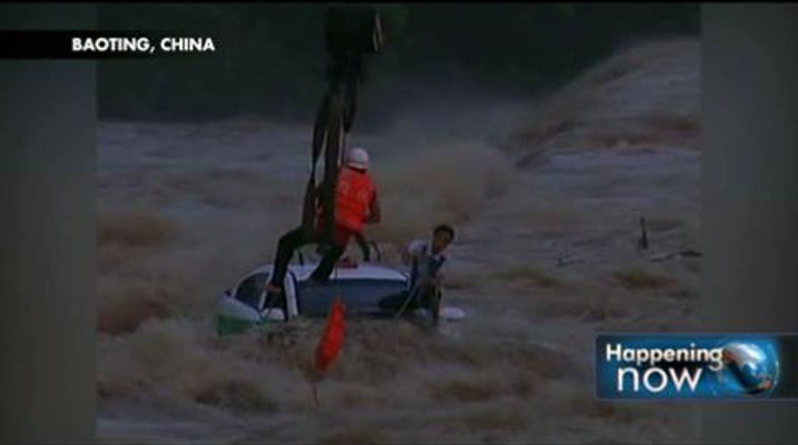 Incredible Video: Taxi Driver and Passenger Dramatically Rescued From Flooded Chinese Dam