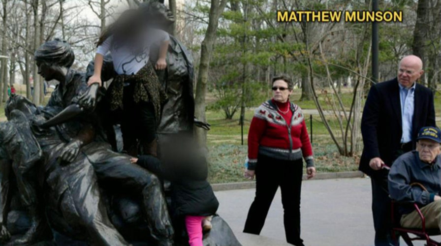 Pic of kids climbing Vietnam Women's Memorial sparks fury
