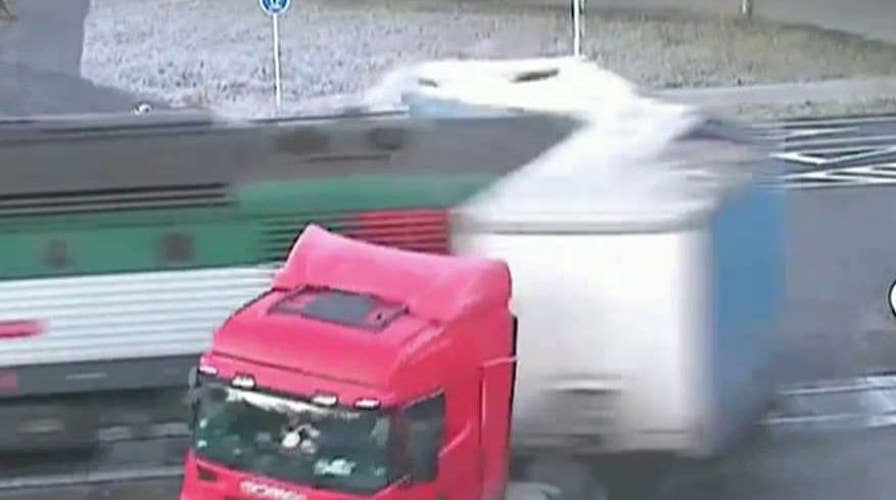 Train plows into semi-truck's trailer