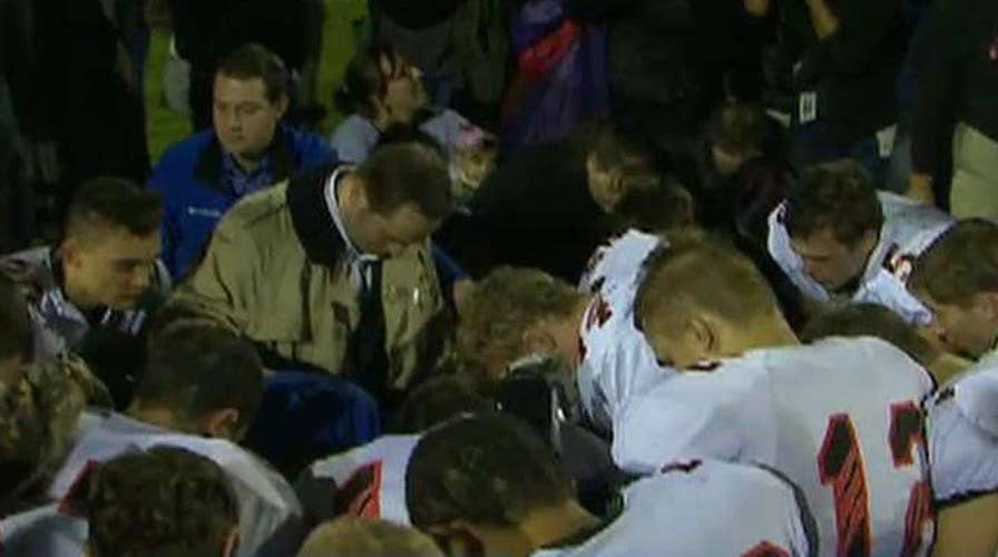 Praying high school football coach files discrimination suit