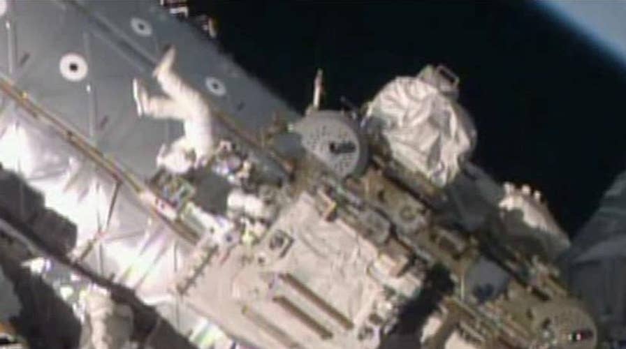 Astronauts work to free rail car jammed outside ISS
